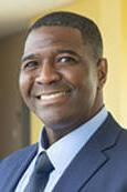 Head shot of Robin Cole smiling wearing a suit with tie.